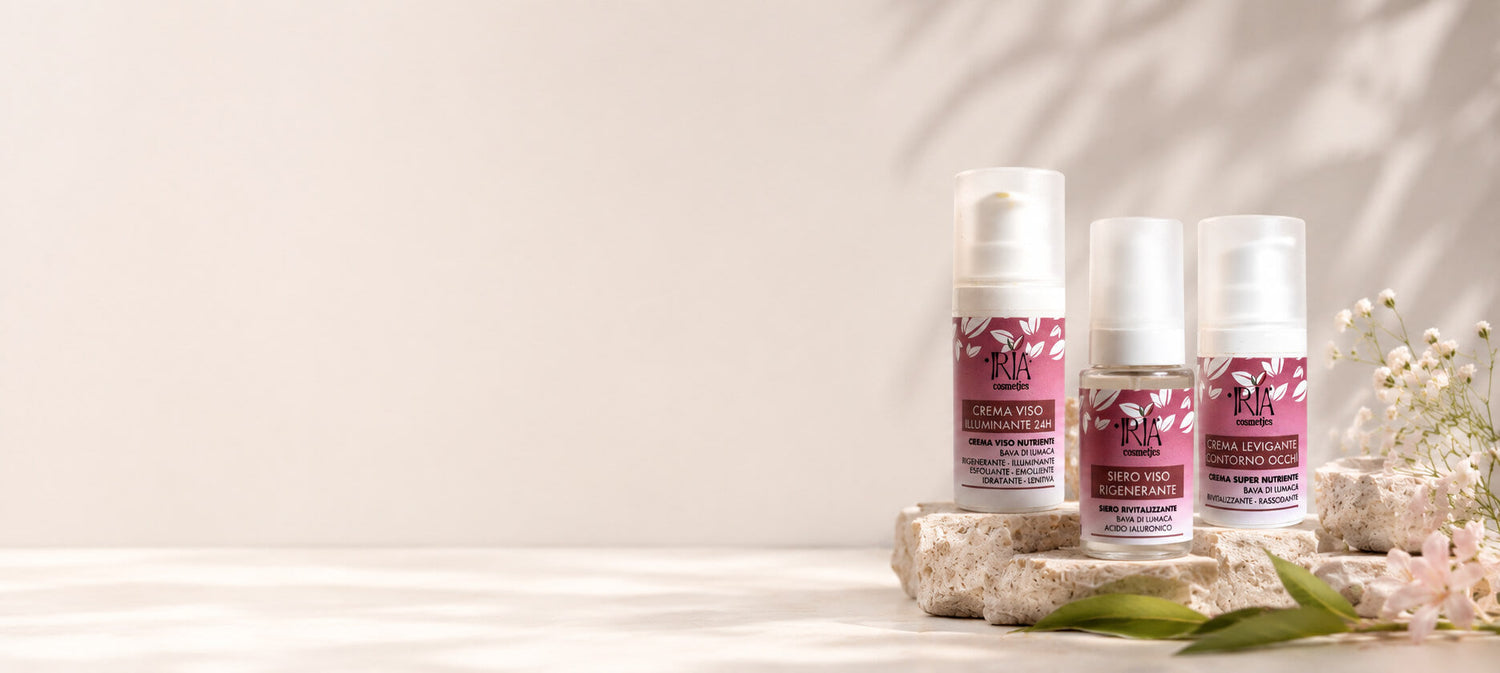 Prodotti viso IRIA Cosmetics alla bava di lumaca: siero, crema viso e contorno occhi su sfondo naturale
